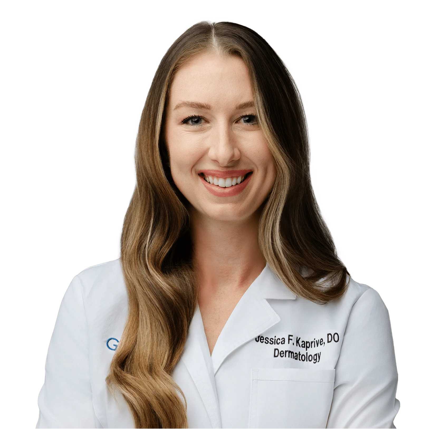 A smiling woman with long, wavy brown hair is wearing a white medical coat. The coat has her name, "Jessica F. Kaprive, DO," and the word "Dermatology" embroidered on it. The background is solid black, highlighting her cheerful expression and professional attire.
